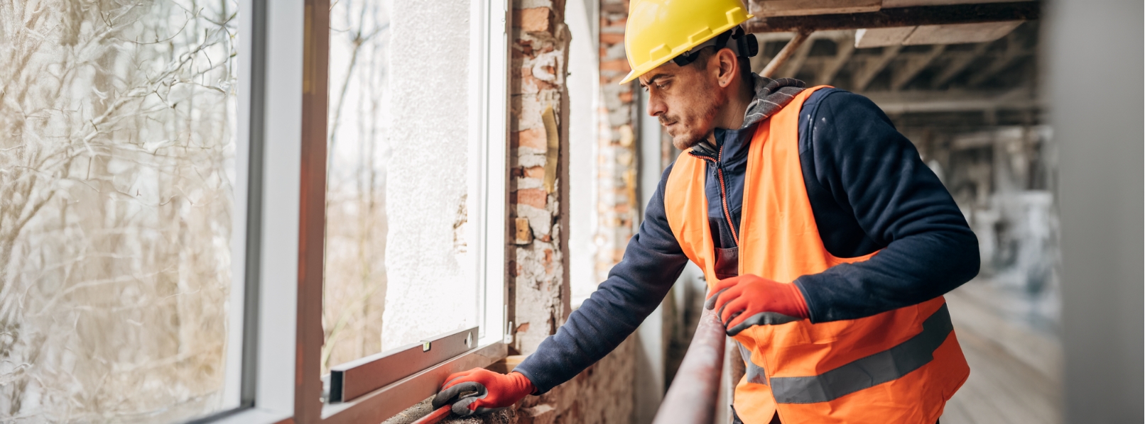 Insurcomm Homepage Banner Insurcomm Construction worker installing new window